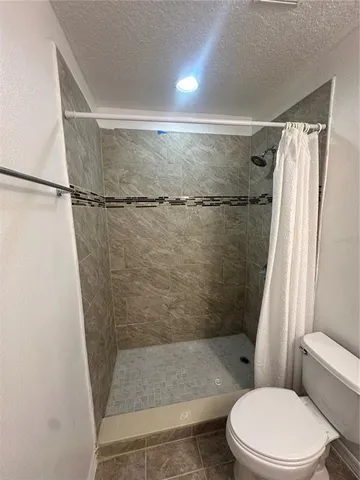 an empty room with windows and cabinet