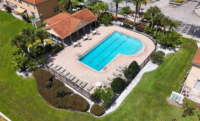 an aerial view of residential houses with outdoor space and river