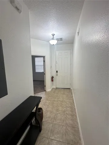 an empty room with a mirror and a ceiling fan