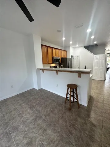 a kitchen with a table chairs refrigerator and microwave