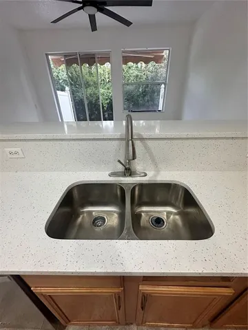 a kitchen sink with cabinets