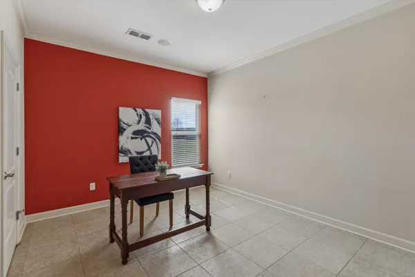 an empty room with windows and ceiling fan