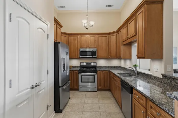 a view of a dining room with furniture and chandelier