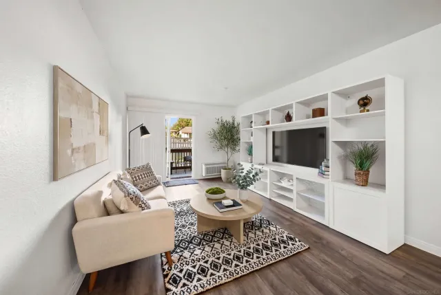 a living room with furniture a rug and a flat screen tv