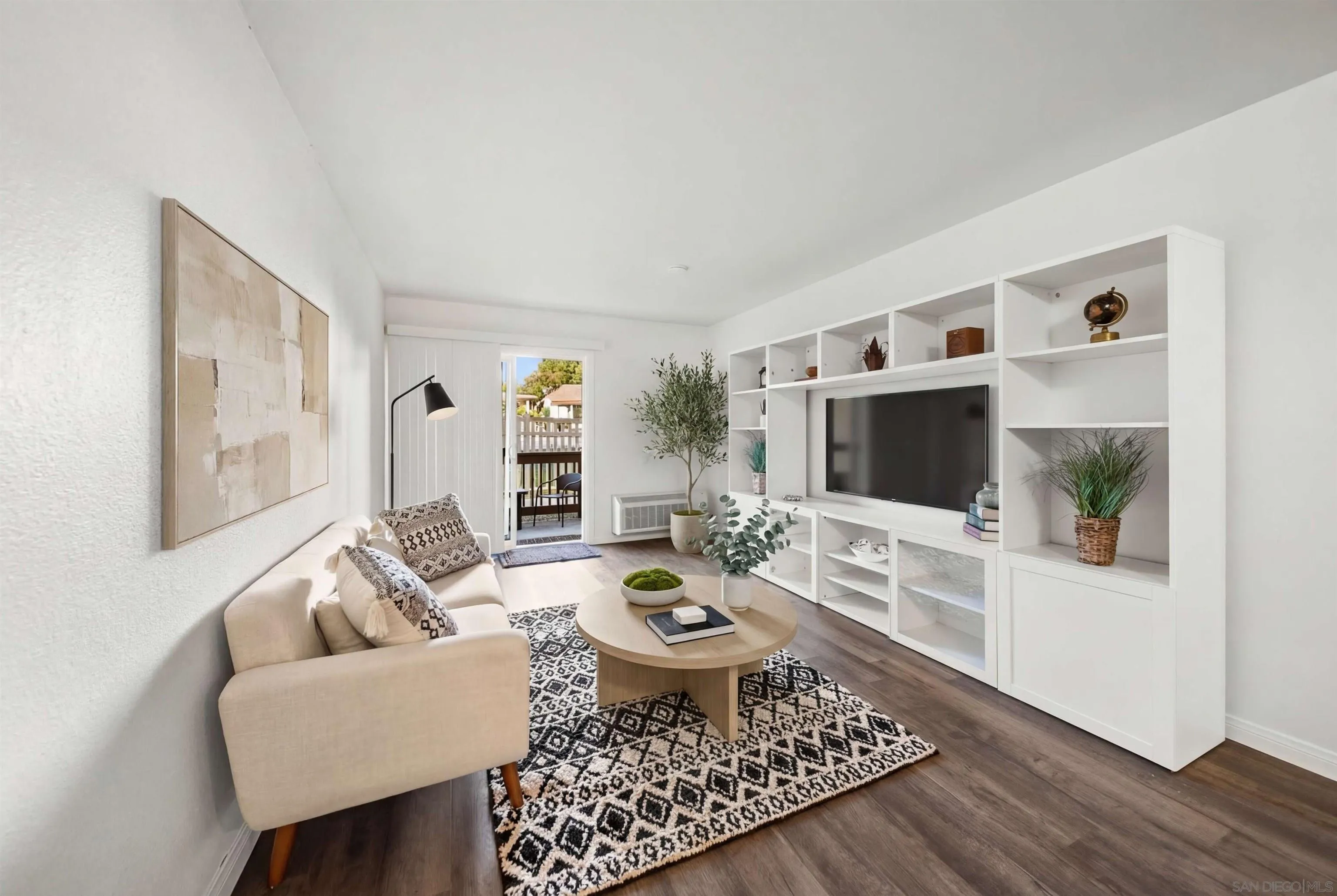 6191 Rancho Mission Road, Unit 103 San Diego, CA 92108 - Photo 1 of 28 a living room with furniture a rug and a flat screen tv