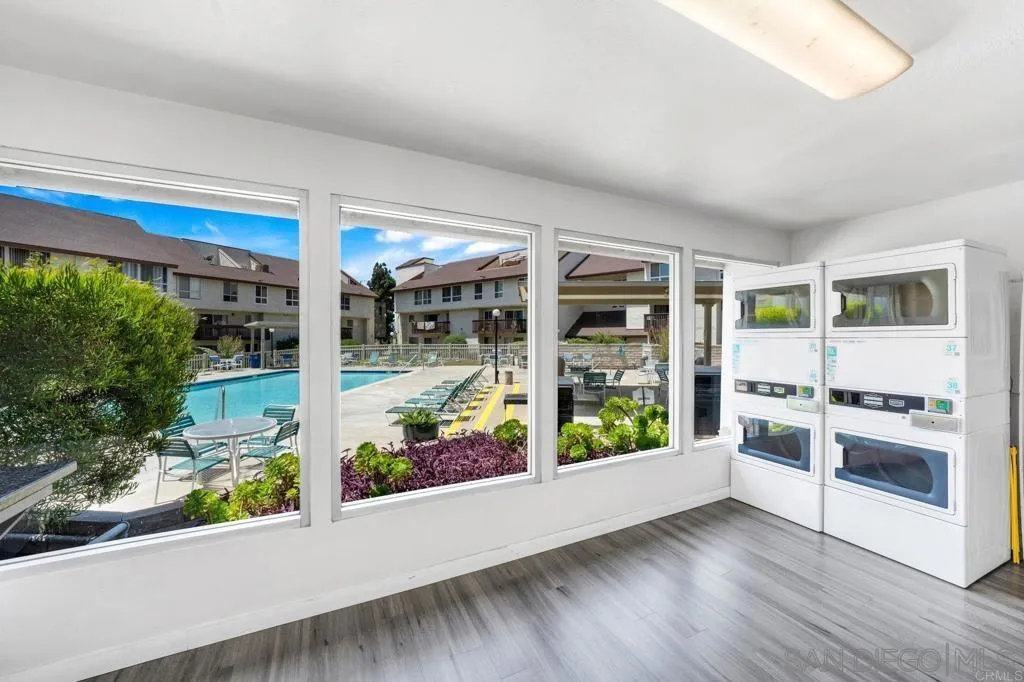 6191 Rancho Mission Road, Unit 103 San Diego, CA 92108 - Photo 20 of 28 a kitchen with stove and wooden floor