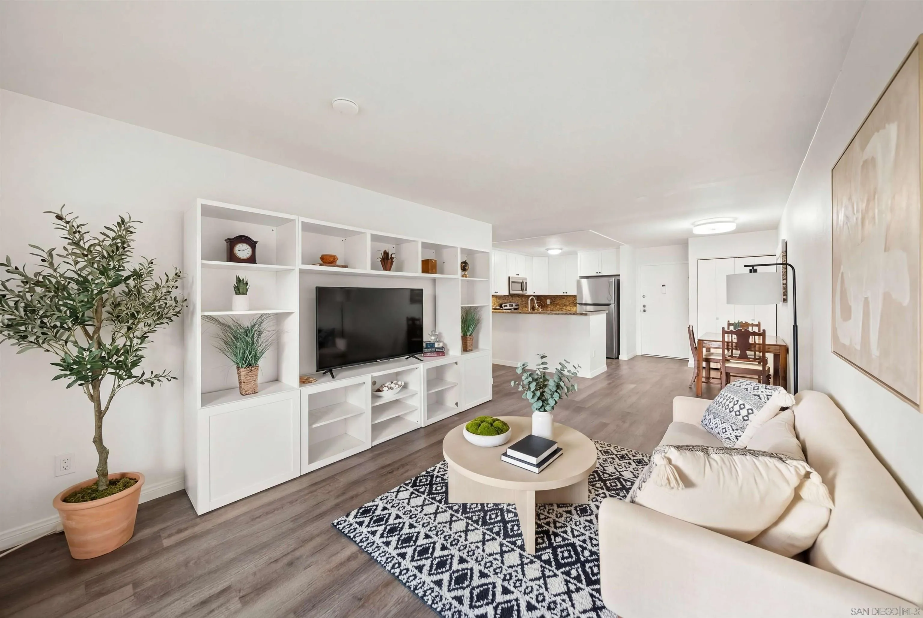 6191 Rancho Mission Road, Unit 103 San Diego, CA 92108 - Photo 2 of 28 a living room with furniture and a flat screen tv