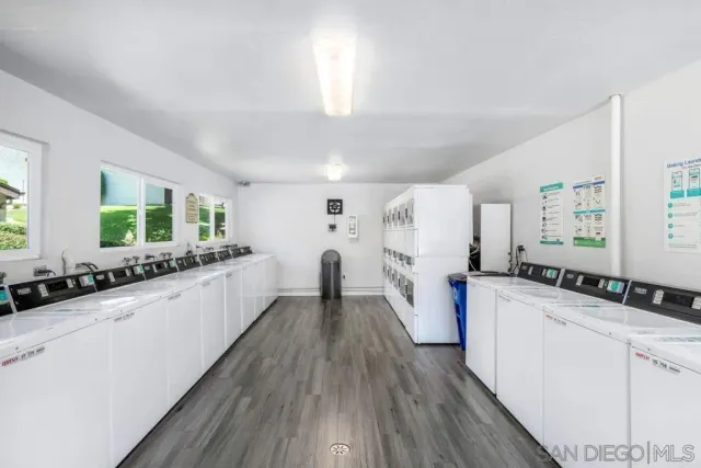 a kitchen with a sink and wooden floor
