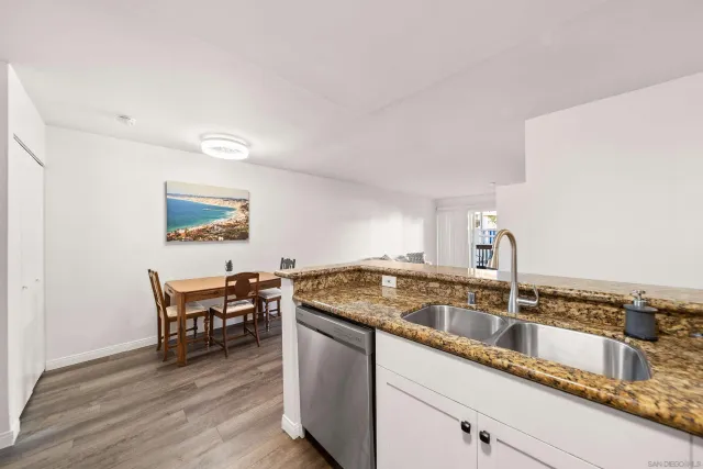 a kitchen with stainless steel appliances granite countertop a sink and a stove
