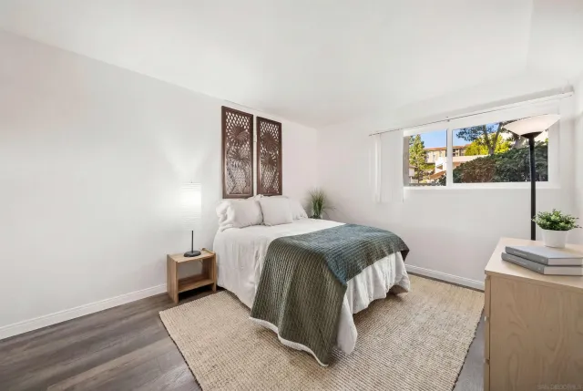 a spacious bedroom with a bed and a window