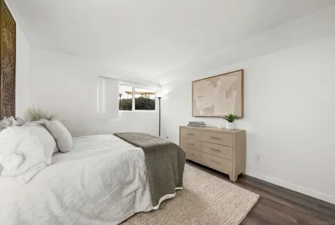 a bedroom with a bed and a dresser