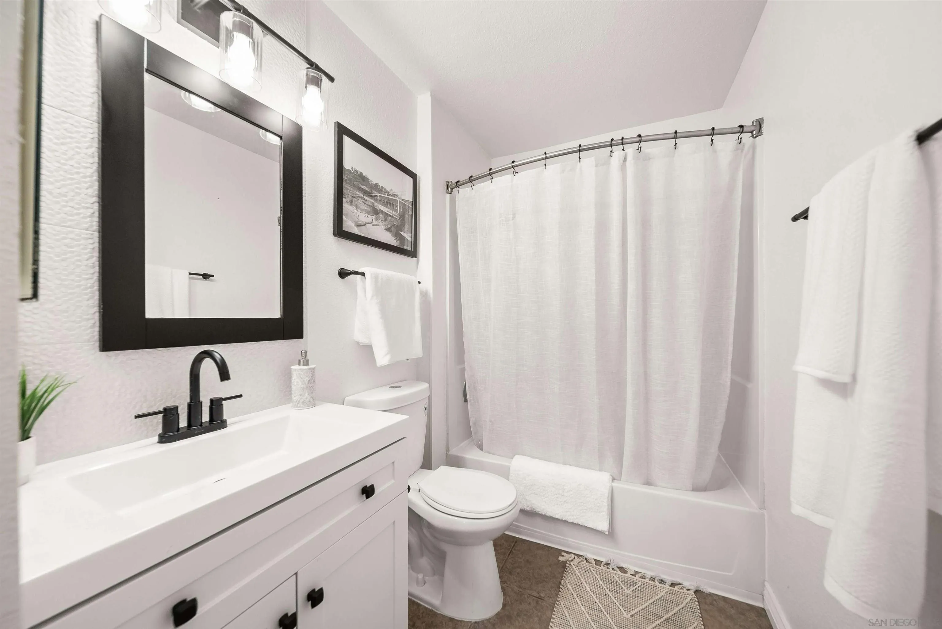6191 Rancho Mission Road, Unit 103 San Diego, CA 92108 - Photo 10 of 28 a bathroom with a toilet a sink and a mirror