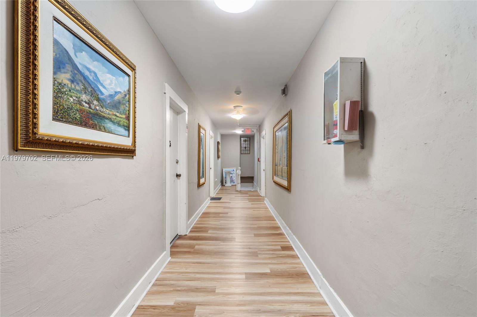 3409 South Le Jeune Road Coral Gables, FL 33134 - Photo 46 of 53 a view of a hallway with wooden floor and stairs