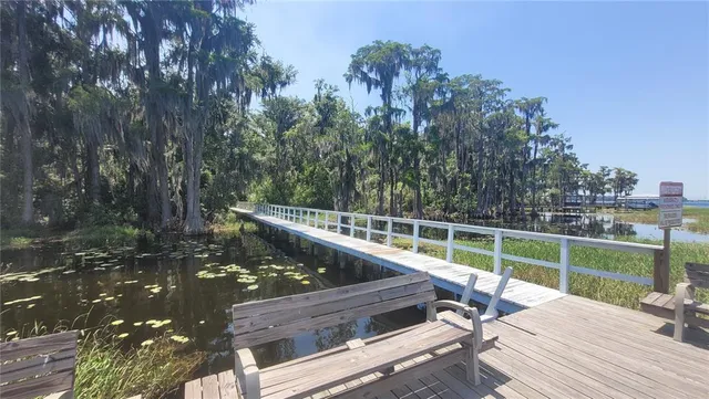 a view of a wooden deck with chairs