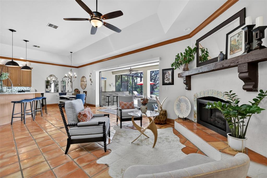 16238 East Shirley Shores Road Tavares, FL 32778 - Photo 12 of 48 a living room with patio furniture and a fireplace