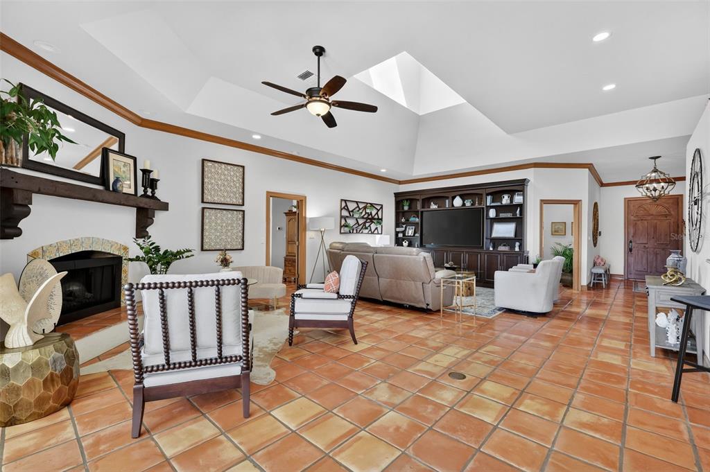 16238 East Shirley Shores Road Tavares, FL 32778 - Photo 13 of 48 a living room with furniture a fireplace and a flat screen tv