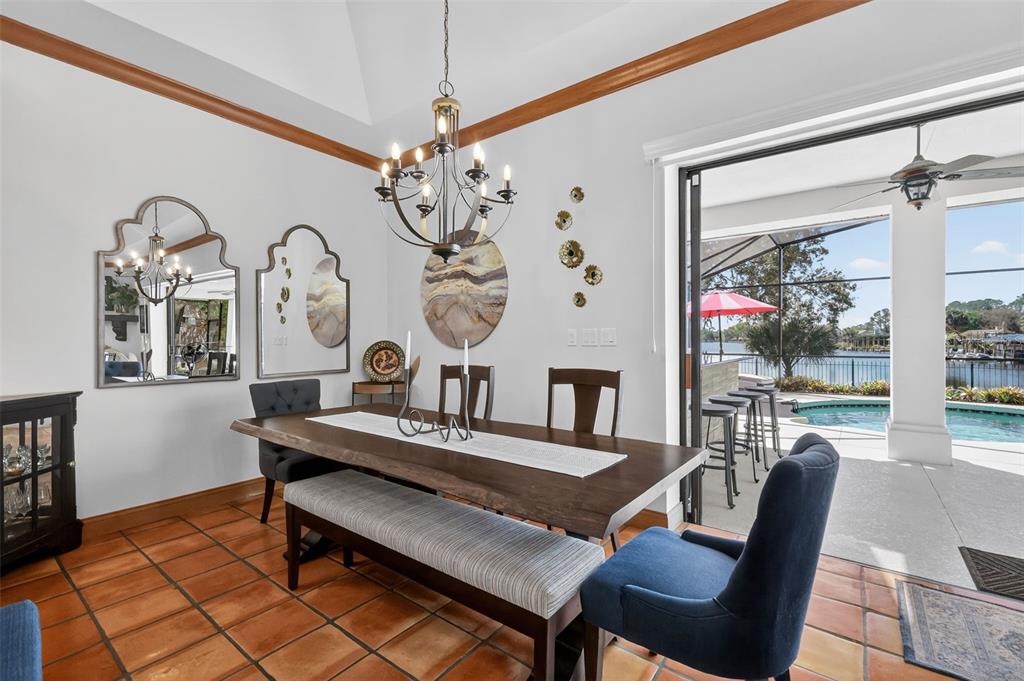 16238 East Shirley Shores Road Tavares, FL 32778 - Photo 14 of 48 a view of a dining room with furniture a chandelier and wooden floor