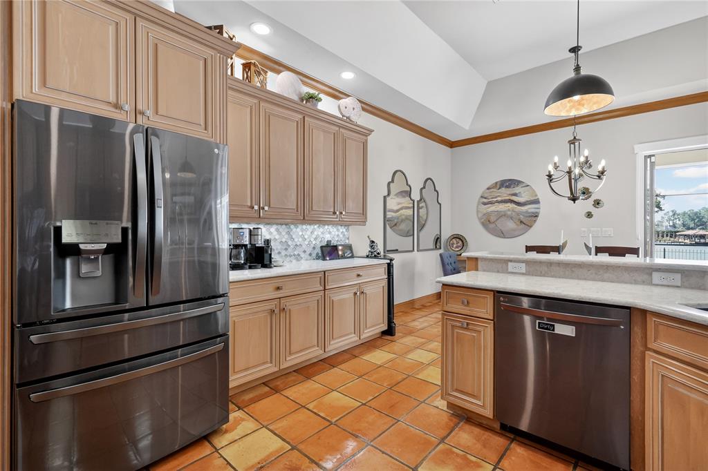 16238 East Shirley Shores Road Tavares, FL 32778 - Photo 17 of 48 a kitchen with stainless steel appliances granite countertop a refrigerator sink and cabinets