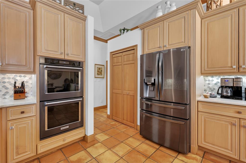 16238 East Shirley Shores Road Tavares, FL 32778 - Photo 18 of 48 a kitchen with cabinets stainless steel appliances and a window
