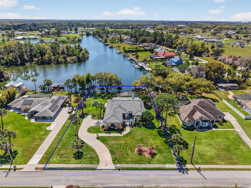 16238 East Shirley Shores Road Tavares, FL 32778 - Photo 2 of 48 an aerial view of a house with outdoor space