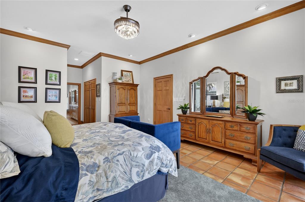 16238 East Shirley Shores Road Tavares, FL 32778 - Photo 21 of 48 a bedroom with a bed window and a mirror on dresser
