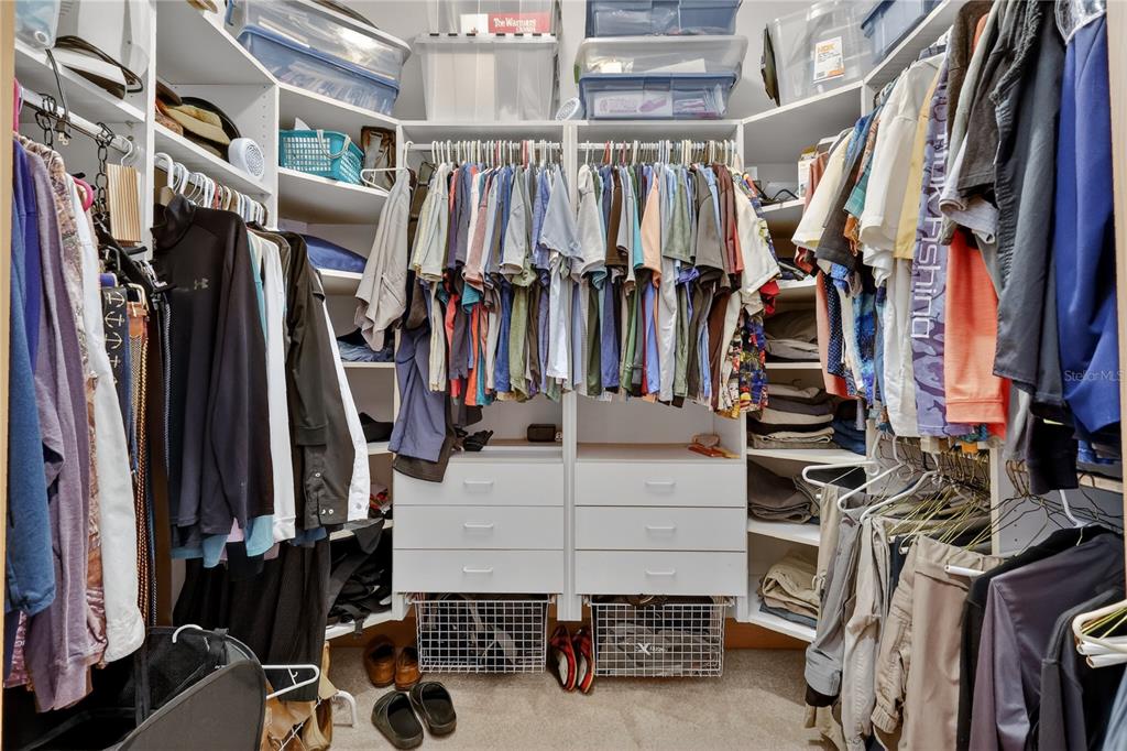 16238 East Shirley Shores Road Tavares, FL 32778 - Photo 22 of 48 a view of walk in closet with clothes and shoes