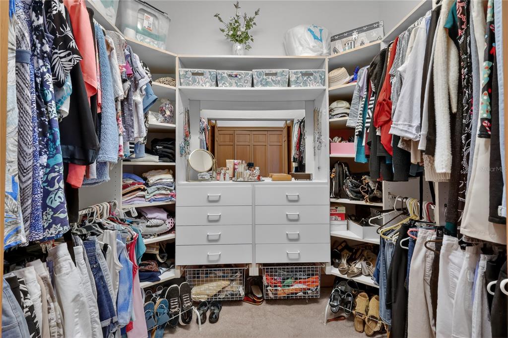 16238 East Shirley Shores Road Tavares, FL 32778 - Photo 23 of 48 a view of walk in closet with clothes and shoes