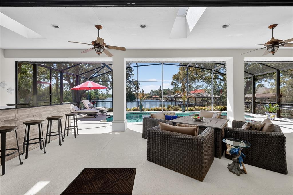 16238 East Shirley Shores Road Tavares, FL 32778 - Photo 35 of 48 a living room with furniture and a floor to ceiling window