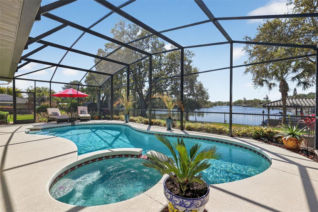 16238 East Shirley Shores Road Tavares, FL 32778 - Photo 38 of 48 a view of a swimming pools under an umbrella