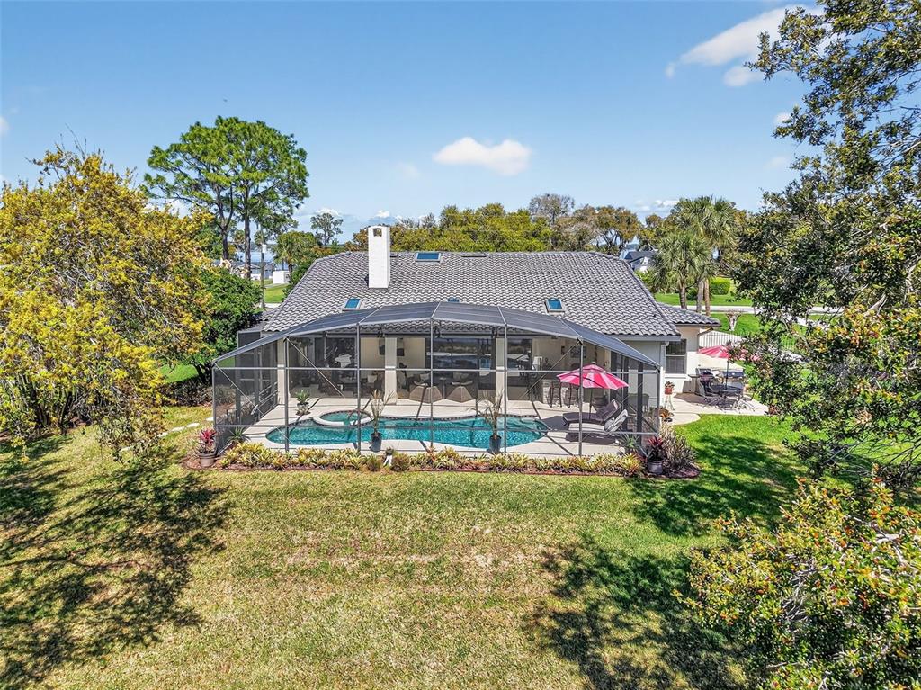 16238 East Shirley Shores Road Tavares, FL 32778 - Photo 46 of 48 a view of a big house with a big yard and large trees