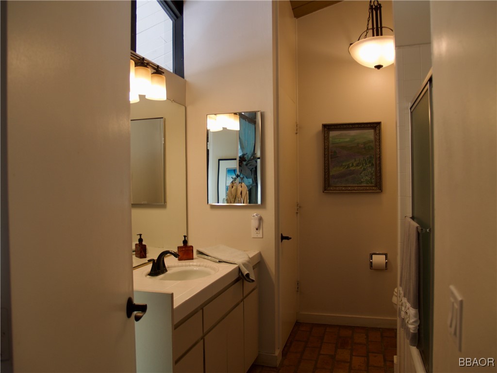 872 Sierra Vista Drive, Unit 9 Twin Peaks, CA 92391 - Photo 13 of 23 a bathroom with a sink and a mirror