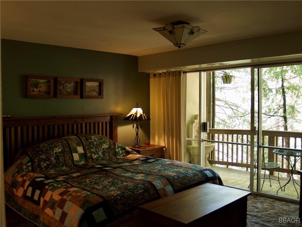 872 Sierra Vista Drive, Unit 9 Twin Peaks, CA 92391 - Photo 15 of 23 a bed sitting in a bedroom next to a window