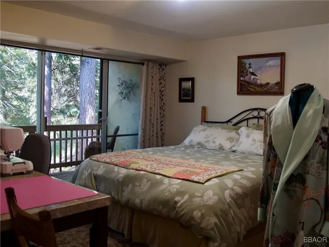 a bedroom with a bed and dresser