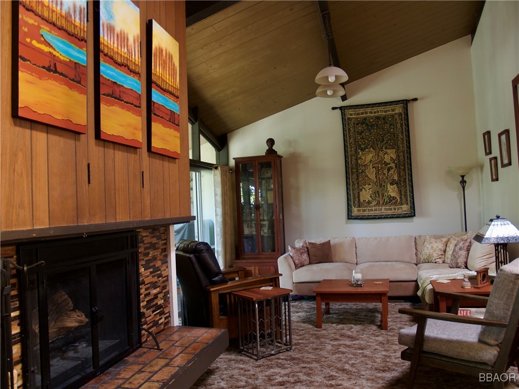 872 Sierra Vista Drive, Unit 9 Twin Peaks, CA 92391 - Photo 5 of 23 a living room with furniture a fireplace and a window