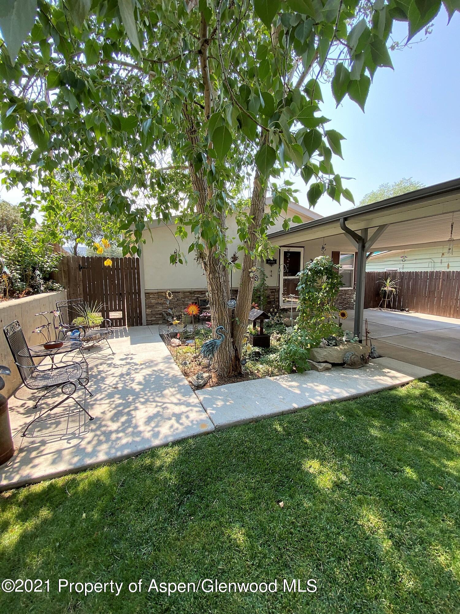 429 East 4th Street Rifle, CO 81650 - Photo 7 of 29 a backyard of a house with table and chairs