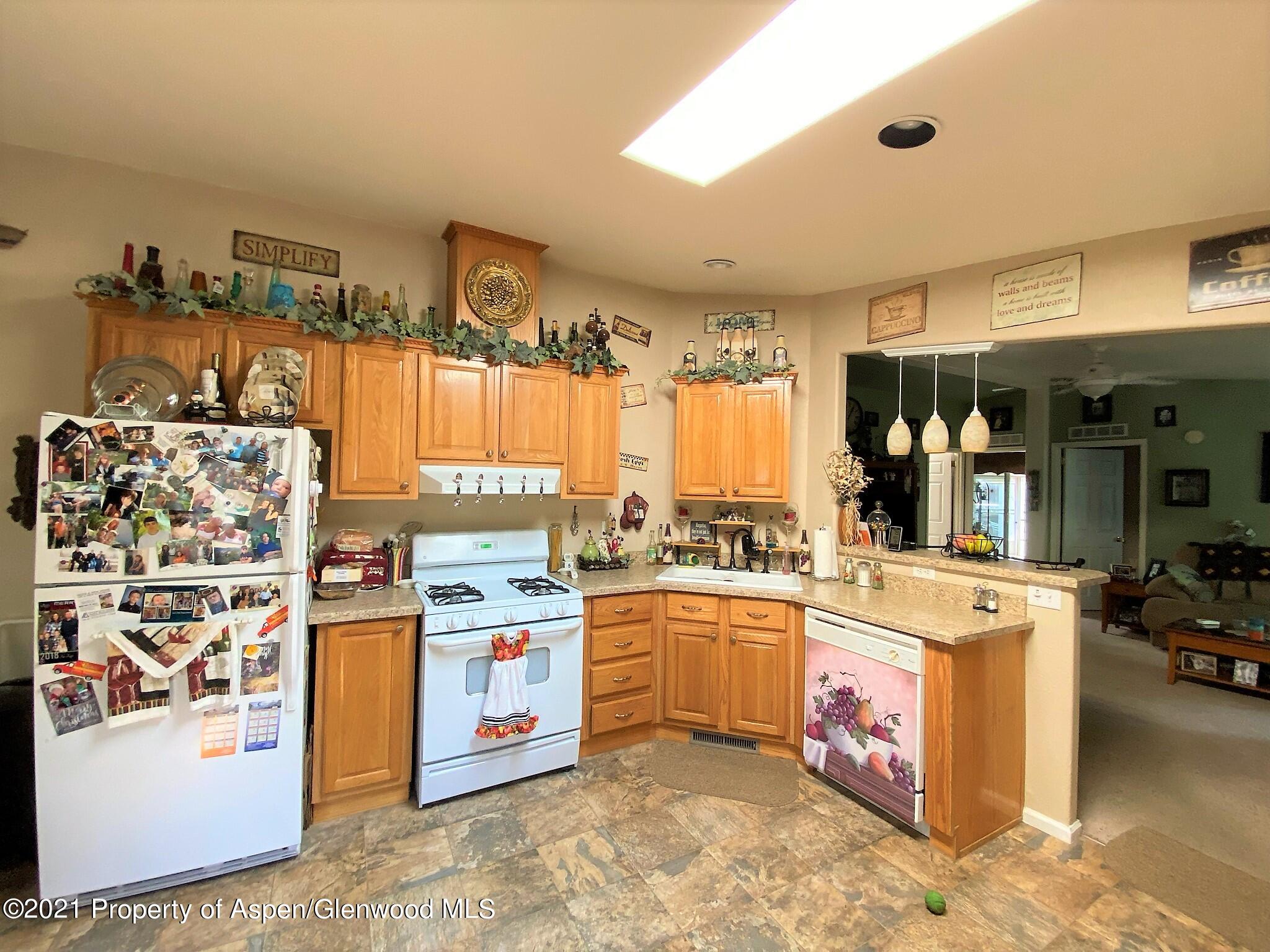 429 East 4th Street Rifle, CO 81650 - Photo 8 of 29 a kitchen with a stove a refrigerator and cabinets