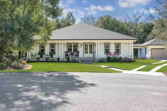 a view of house with outdoor space and garden