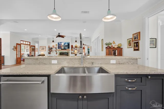 a large kitchen with stainless steel appliances granite countertop a lot of counter space and a sink