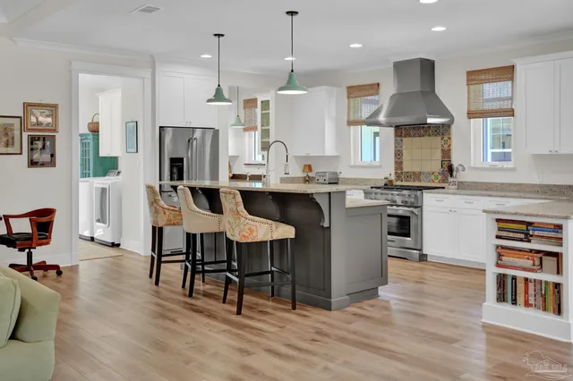 a living room with furniture a bookshelf and a chandelier
