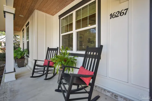 a view of a two chairs in the back yard of the house