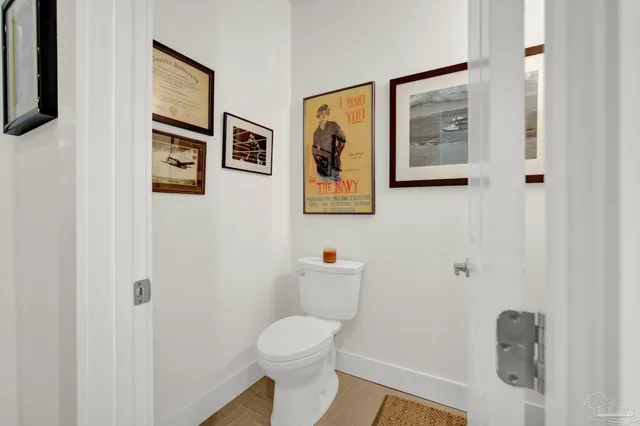 a living room with furniture a ceiling fan and a large window