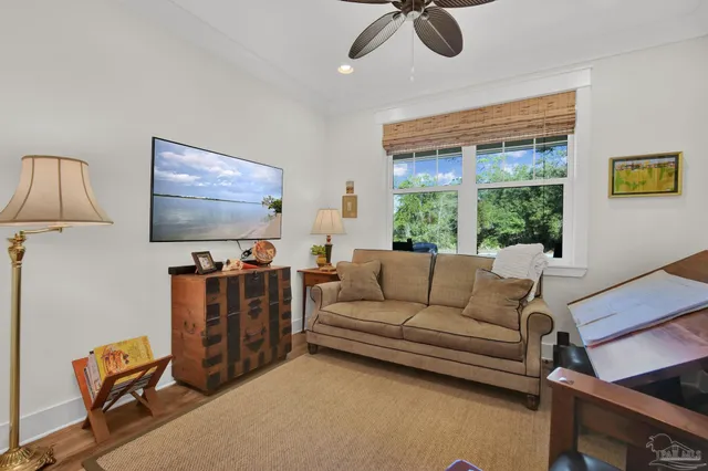 a bathroom with a toilet and a painting on the wall
