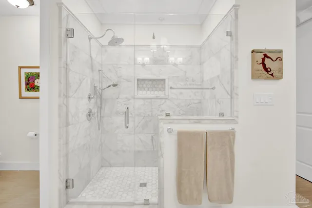 a view of a work space with furniture and floor to ceiling window