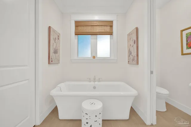 a dining room with furniture water view and large windows