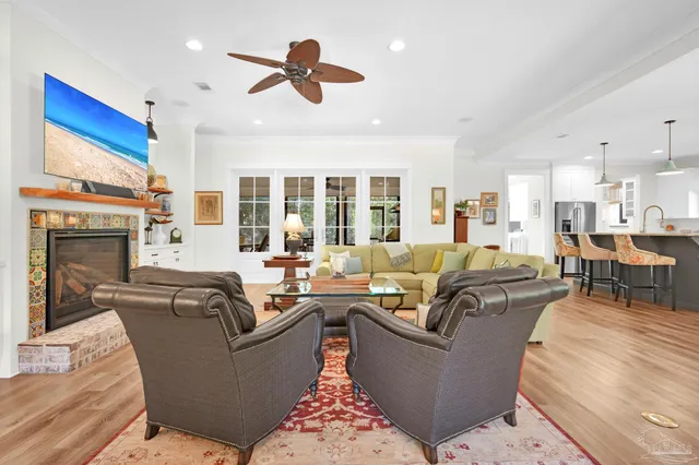 a living room with furniture or large window and wooden floor