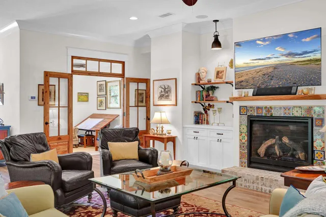 a kitchen with stainless steel appliances granite countertop a kitchen island a stove a sink dishwasher a dining table and chairs with wooden floor