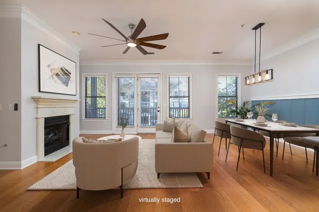 a living room with furniture a large window and a fireplace