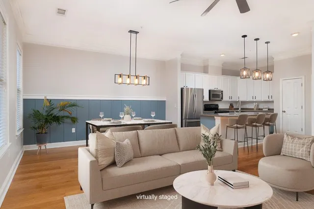 a living room with furniture and kitchen view