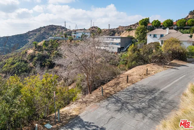 a view of a houses with mountains in the background