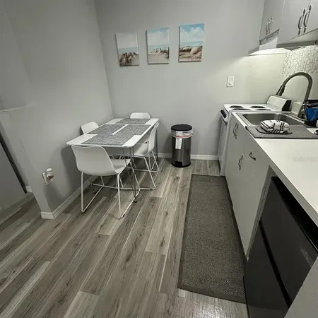 a open kitchen with a table and chairs